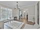 Bright living room featuring a decorative chandelier, light grey walls, and hardwood flooring at 2112 Highway 54, Moreland, GA 30259