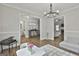 Open-concept living room showcasing hardwood floors, wainscoting, and views into other rooms at 2112 Highway 54, Moreland, GA 30259