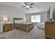 Cozy main bedroom with a ceiling fan, carpet, and large window for natural light at 2112 Highway 54, Moreland, GA 30259
