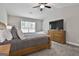 Comfortable main bedroom featuring carpet, a ceiling fan, and natural light at 2112 Highway 54, Moreland, GA 30259