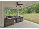Enjoy the outdoors under this covered patio with outdoor furniture and ceiling fan at 2112 Highway 54, Moreland, GA 30259