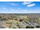 Expansive aerial shot showcases a clubhouse, parking lot, and scenic golf course landscape on a sunny day at 157 Glen Eagle Way, Mcdonough, GA 30253
