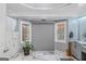 Bathroom showcasing decorative windows, grey walls, marble floors, and modern fixtures at 157 Glen Eagle Way, Mcdonough, GA 30253