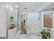 Bright bathroom featuring marble floors and walls, a glass-enclosed shower, and a decorative plant at 157 Glen Eagle Way, Mcdonough, GA 30253