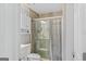 Bathroom featuring a glass shower with tile and a white toilet and vanity at 157 Glen Eagle Way, Mcdonough, GA 30253