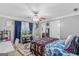 Bedroom with a colorful quilt, ceiling fan, desk, and TV area at 157 Glen Eagle Way, Mcdonough, GA 30253