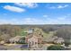 Impressive clubhouse featuring a grand entrance and panoramic views of the surrounding golf course and serene lake at 157 Glen Eagle Way, Mcdonough, GA 30253