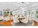 Open-concept dining room with modern chandelier, stone fireplace, and hardwood floors at 157 Glen Eagle Way, Mcdonough, GA 30253