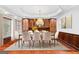 Elegant dining room with a chandelier, wood paneling, and built-in cabinetry at 157 Glen Eagle Way, Mcdonough, GA 30253