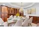 Elegant dining room with a chandelier, built-in cabinetry, and seating for eight at 157 Glen Eagle Way, Mcdonough, GA 30253