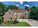 Stately brick home with a circular driveway and professionally landscaped grounds at 157 Glen Eagle Way, Mcdonough, GA 30253