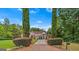 Grand brick home with a long driveway framed by mature trees and lush greenery at 157 Glen Eagle Way, Mcdonough, GA 30253