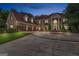 Elegant brick home with a circular driveway and meticulously maintained front lawn, captured at twilight at 157 Glen Eagle Way, Mcdonough, GA 30253