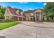 Traditional brick home with a circular driveway and well-manicured lawn at 157 Glen Eagle Way, Mcdonough, GA 30253