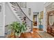 Inviting foyer showcases a staircase with iron railings and hardwood floors at 157 Glen Eagle Way, Mcdonough, GA 30253
