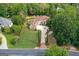 Stately brick home featuring a circular driveway, lush lawn, and mature trees, offering an inviting curb appeal at 157 Glen Eagle Way, Mcdonough, GA 30253