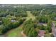 Scenic aerial view of a lush golf course, featuring well-maintained greens and mature trees at 157 Glen Eagle Way, Mcdonough, GA 30253