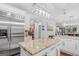 Open kitchen with stainless steel refrigerator, granite island, and hardwood floors at 157 Glen Eagle Way, Mcdonough, GA 30253