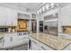 Modern kitchen features stainless steel appliances, granite island, and white cabinetry at 157 Glen Eagle Way, Mcdonough, GA 30253