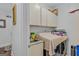 Laundry room featuring cabinets for storage, folding table, and a utility sink at 157 Glen Eagle Way, Mcdonough, GA 30253