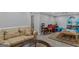 A living room features a tan couch, hardwood floors, and glass coffee table at 157 Glen Eagle Way, Mcdonough, GA 30253
