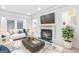 Cozy living room with a fireplace, decorative wall art, and comfortable seating at 157 Glen Eagle Way, Mcdonough, GA 30253