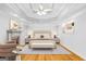 Inviting main bedroom with hardwood floors, fireplace, and a decorative tray ceiling at 157 Glen Eagle Way, Mcdonough, GA 30253