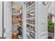 Organized walk-in pantry with white shelving, providing ample storage space for groceries and kitchen essentials at 157 Glen Eagle Way, Mcdonough, GA 30253