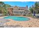 Back of the home showcasing in-ground pool, elevated deck and lush landscaping at 157 Glen Eagle Way, Mcdonough, GA 30253