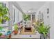Relaxing sunroom filled with plants, wicker chair, and peaceful garden views at 157 Glen Eagle Way, Mcdonough, GA 30253