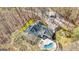 Aerial view of a home with lush landscaping and a backyard pool with a patio area at 313 Dingler Rd, Moreland, GA 30259