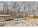 Backyard featuring a gravel area with a shed, and a wooded area at 313 Dingler Rd, Moreland, GA 30259