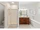 Bright bathroom with a wooden vanity, separate shower, and soaking tub at 313 Dingler Rd, Moreland, GA 30259