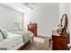 Neutral bedroom showcasing carpeted floors, a ceiling fan, and classic wood furniture pieces at 313 Dingler Rd, Moreland, GA 30259