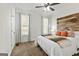 Cozy bedroom featuring a rustic wooden headboard and neutral decor with plenty of natural light at 313 Dingler Rd, Moreland, GA 30259