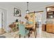 Charming dining area with round wood table, wainscoting, decorative sliding barn door and tile floors at 313 Dingler Rd, Moreland, GA 30259