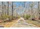 Long driveway leading to a home with a gate at 313 Dingler Rd, Moreland, GA 30259