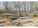 Long driveway features a carport, propane tank and landscaping at 313 Dingler Rd, Moreland, GA 30259