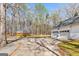 Wide driveway leading to a two-car garage and separate shed, set in a wooded area at 313 Dingler Rd, Moreland, GA 30259
