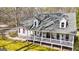 Inviting two-story house with a spacious front porch and dormer windows at 313 Dingler Rd, Moreland, GA 30259