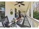 Relaxing front porch with rocking chairs and ceiling fans, perfect for outdoor living at 313 Dingler Rd, Moreland, GA 30259