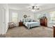 Comfortable main bedroom with plush carpet, natural light, and a ceiling fan at 313 Dingler Rd, Moreland, GA 30259