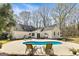 Backyard featuring an in-ground pool, patio with furniture, and a wooded perimeter at 313 Dingler Rd, Moreland, GA 30259