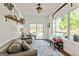 Inviting sunroom features a comfortable seating area, sliding glass doors to the outside, and lots of natural light at 313 Dingler Rd, Moreland, GA 30259
