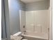 This bathroom features a shower-tub combination with white walls at 40 Canterbury Dr, Grantville, GA 30220