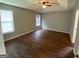 Spacious bedroom featuring neutral paint, natural light, ceiling fan, and hardwood floors at 40 Canterbury Dr, Grantville, GA 30220