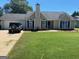 Charming single-story home with well-maintained lawn, attached garage, and traditional architecture at 40 Canterbury Dr, Grantville, GA 30220