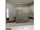 Efficient kitchen layout with white cabinetry and essential appliances for a functional cooking space at 40 Canterbury Dr, Grantville, GA 30220