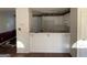 Cozy kitchen featuring white cabinets, a breakfast bar, and open access to the adjacent living spaces at 40 Canterbury Dr, Grantville, GA 30220