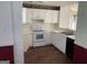 Well-lit kitchen featuring white cabinetry and essential appliances for a functional cooking space at 40 Canterbury Dr, Grantville, GA 30220